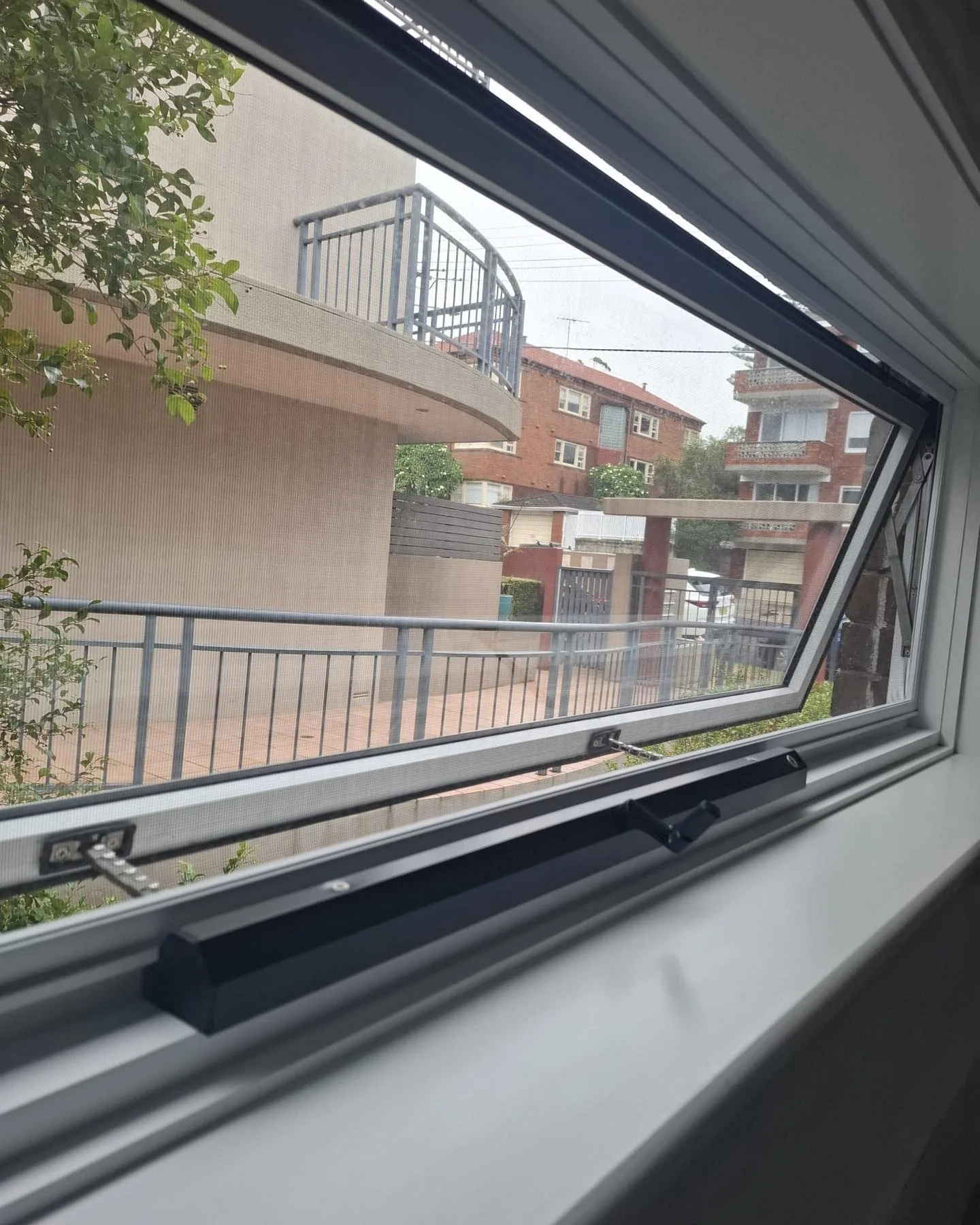 Custom made panoramic awning window with twin chain winders