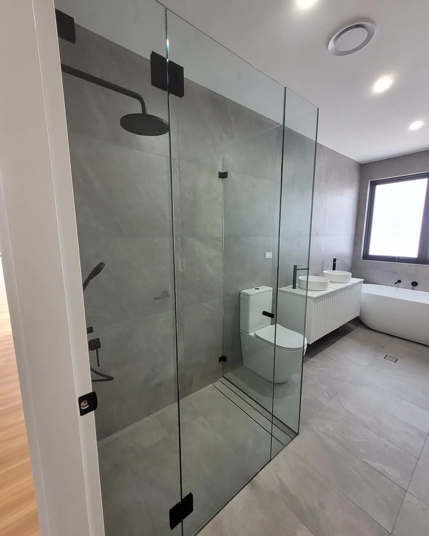 Custom made frameless shower screen